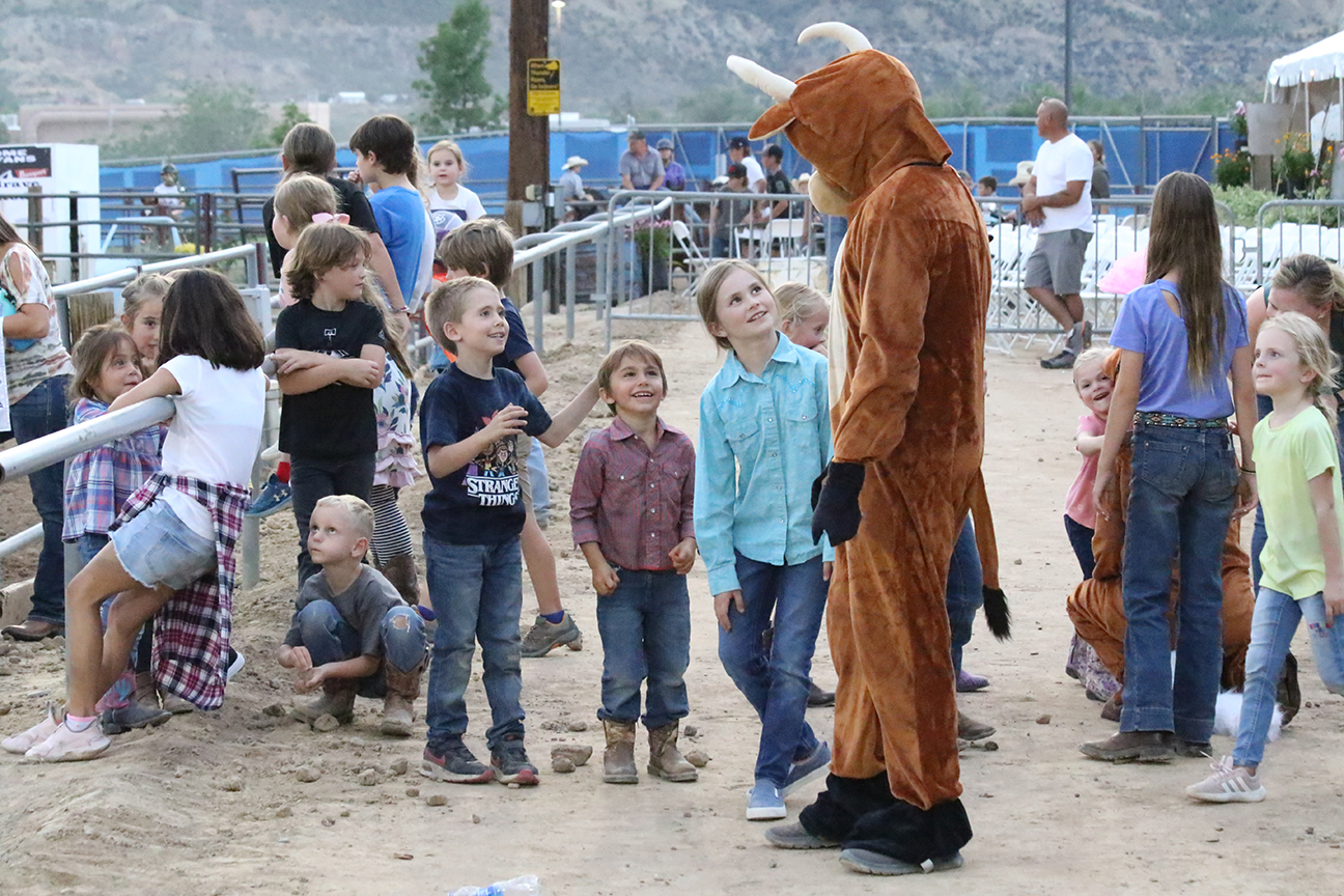 Kids with bull fair mascot at the Garfield County Fairgrounds