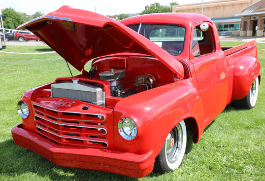 A red, classic pickup truck at the Garfield County Fair and Rodeo car show.