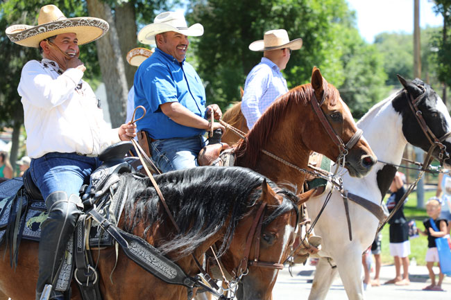 men riding horses in parade