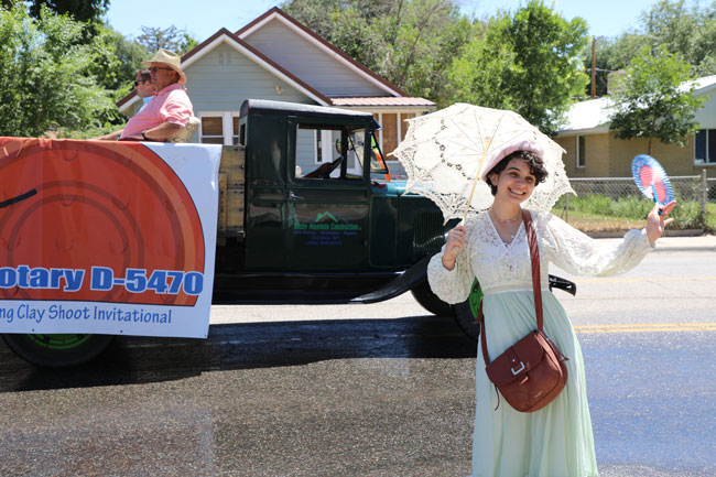 women in old fashion clothes in a parade